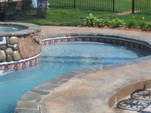 A gradual entry large step/sun shelf area on a vinyl liner pool. Not technically a beach entry area, but similar in concept and function, a great option for this homeowner in Novi, MI