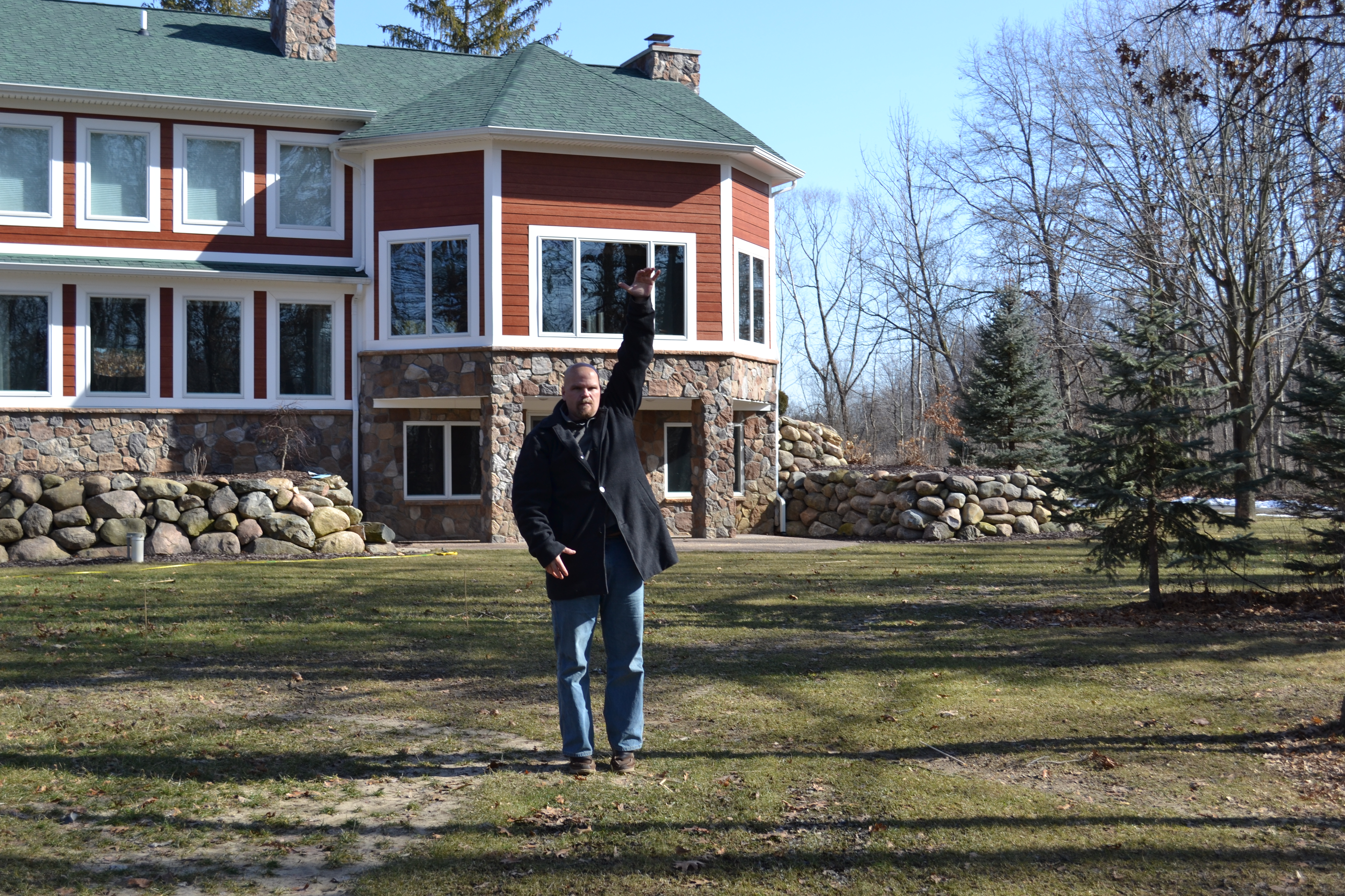 Al Curtis, of Legendary Escapes, stands in the middle of a new construction site mentally building the pool. He marks where the water line will be when the pool is finished.