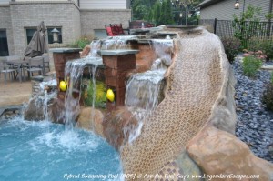 This custom, hand-carved waterfall and rock slide features beautiful lighting and a personalized mural.